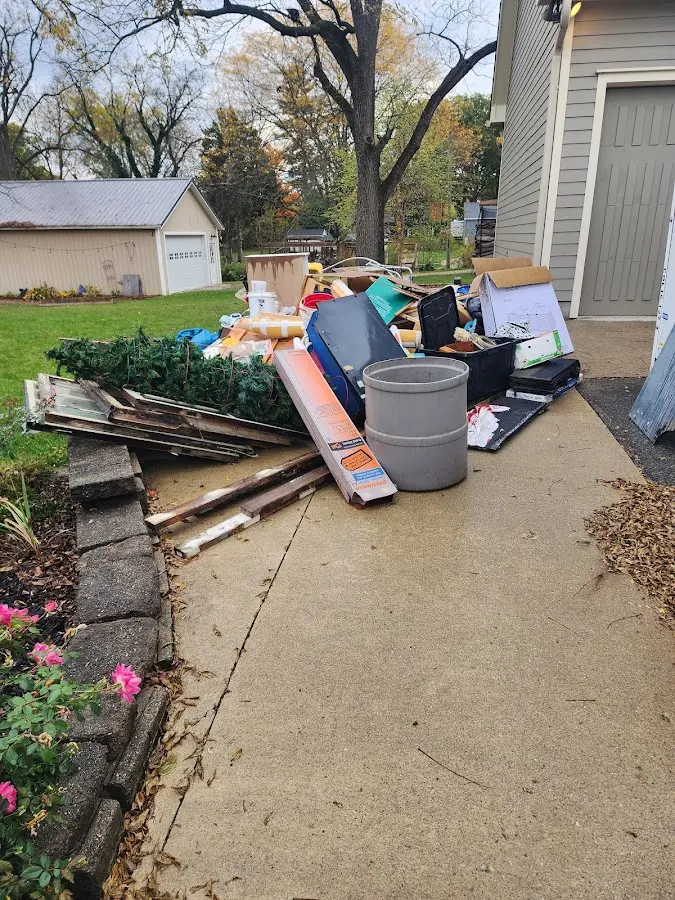 Dumpster being loaded with debris for Estate Cleanout Dumpster Rental in Menasha